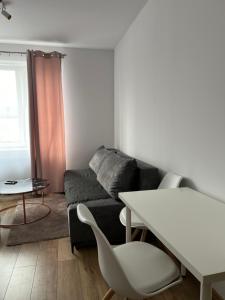 a living room with a couch and a table at Best for 2 in Pabianice +2 photos