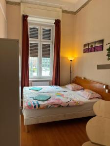 a bedroom with two beds and a window at Good Luck in Budapest