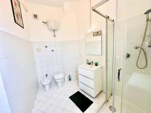 a white bathroom with a shower and a toilet at Attico lussuoso Roma centro in Rome