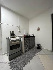 a kitchen with a stove top oven in a room at Toca do Tatu in Itu