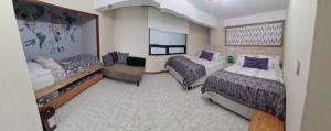 a hotel room with two beds and a couch at Apartamento Riviera, lake Panajachel in San Jorge La Laguna +31 photos