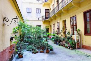 a courtyard with potted plants on the side of a building at Supreme Astoria Semmelweis in Budapest