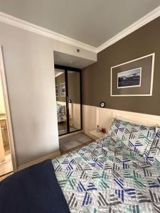 a bedroom with a bed and a mirror at HOTEL PERDIZES - FLAT Executivo - 1204 in São Paulo