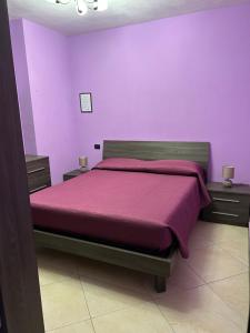 um quarto roxo com uma cama com paredes roxas em Apartment Sabine em Roma