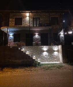 a building with stairs in front of it at night at Charoula Pavliani Fthiotidas in Pávliani