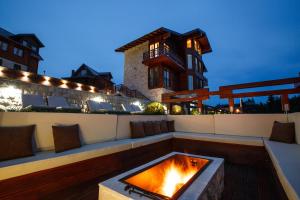 a patio with a fire pit on top of a building at Hotel NORTH STORY - Luxury Chalet - Apartments & rooms in Žabljak