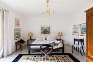 a bedroom with a bed and a chandelier at Villa Ani in Ascona