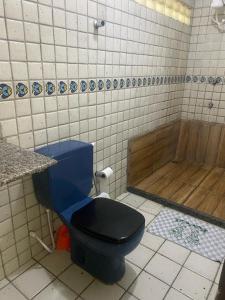 Pousada jardim de cabo branco في جواو بيسوا: حمام به مرحاض أزرق وحوض استحمام