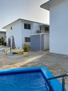 niebieski basen przed domem w obiekcie Joli appartement avec vue sur la piscine w mieście Boca Chica