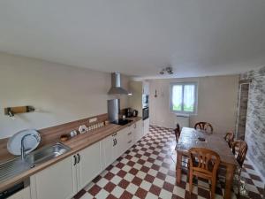 a kitchen with a table and a dining room at Maison 8-10 personnes in Vrocourt +6 photos