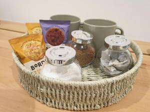 a basket filled with spices and condiments on a table at Fly By in Duxford