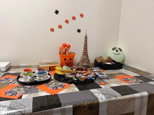 a table with a table cloth with food and the eiffel tower at Sunlit Seine Cottage in Paris