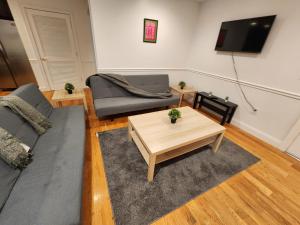 a living room with a couch and a coffee table at Stylish 2BR Apt Mins to NYC! in Union City