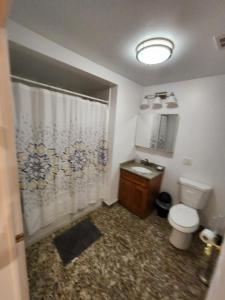 a bathroom with a toilet and a sink and a shower at Stylish 2BR Apt Mins to NYC! in Union City