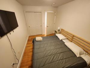 a bedroom with a bed and a flat screen tv at Stylish 2BR Apt Mins to NYC! in Union City