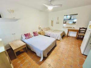 a bedroom with two beds and a table in it at Estudio adosado con jardín y parking privado in Alicante