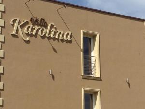 a sign on the side of a building at Villa Karolina in Mielno
