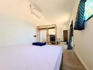 a bedroom with a white bed in a room at Skippers - Adults only in Diani Beach +17 photos