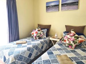 two beds sitting next to each other in a bedroom at Kingfisher E in Shelly Beach