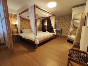 a bedroom with a canopy bed and two bunk beds at Αλώνι in Nimfasía