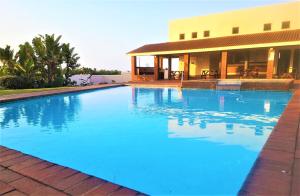 a large blue swimming pool in front of a building at Laguna La Crete L in Margate