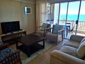 a living room with a couch and chairs and a television at Laguna La Crete L in Margate
