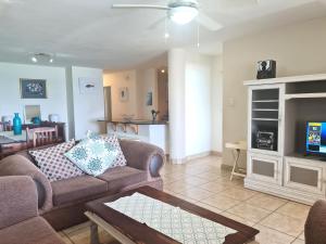 a living room with a couch and a fireplace at Santorini 105A in Margate
