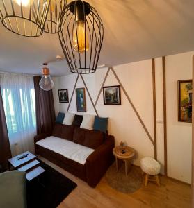 a living room with a couch and a table at Vila Jahor CozyPlace 28 in Jahorina