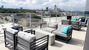 a balcony with chairs and a table on a building at Luxe Mid-Downtown apartment in Houston