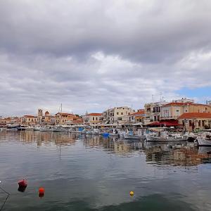 a group of boats docked in a harbor with buildings at La Bandolaise à Perdika in Perdika