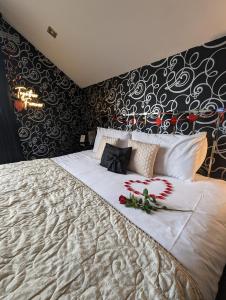 a bedroom with a large bed with flowers on it at FINN VILLAGE - Loch Lomond Villa B&B with a Hot Tub in Glasgow