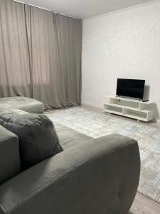 A television and/or entertainment centre at 2 BEDROOM APARTMENT
