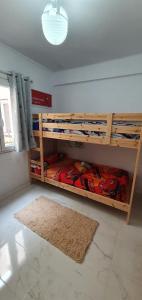 a room with bunk beds with a rug and a window at Sweet flat in Tortosa in Tortosa