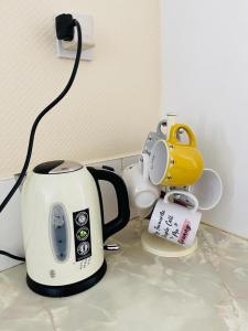a toaster and other appliances sitting on a counter at Cosy flat in Little Paxton