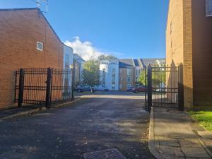 a gate in a street next to a brick building at West Beck House in Darlington