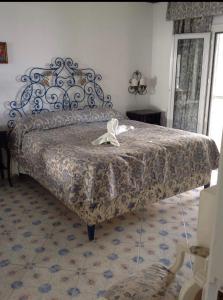 a bedroom with a large bed with a metal frame at la guardia in Anacapri