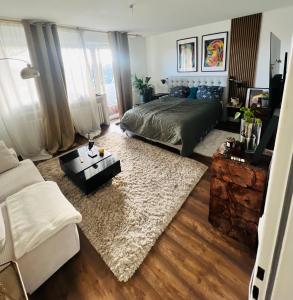 a bedroom with a bed and a living room at Schlafzimmer der Stille in Bochum