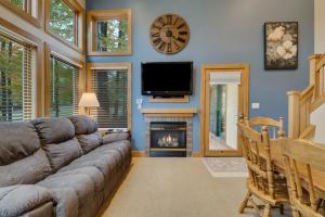 a living room with a couch and a fire place at 604 Disciples Village Condo in Boyne Falls