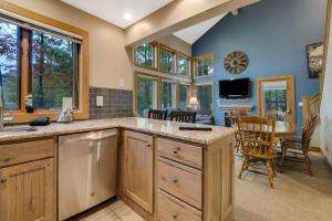 a kitchen with a large island and a dining room at 604 Disciples Village Condo in Boyne Falls