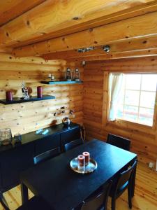 a dining room with a table in a log cabin at Chalet Aroania in Kalavrita +21 photos