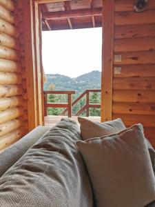 a bed in a room with a view of a window at Chalet Aroania in Kalavrita