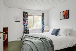 a bedroom with a bed and a window at Large family home by the water in Östhammar