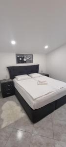 a bedroom with a bed with a white mattressvisor at Villa Marija in Vir