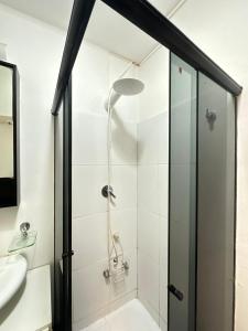 a shower with a glass door in a bathroom at STUDIO COPA IPA ARPOADOR Ap 304 in Rio de Janeiro