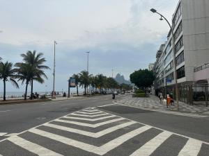 an empty street with a crosswalk on the road at STUDIO COPA IPA ARPOADOR Ap 304 in Rio de Janeiro