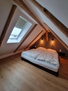 a bedroom with a bed in the attic at Ferienhaus-DP8 in Staupitz