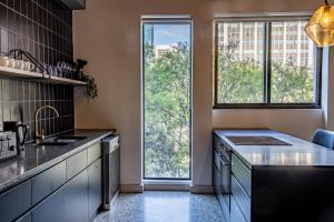 a kitchen with a sink and a large window at 208, The Duke - Luxury apartment with city views in Cape Town