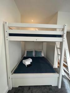 a bunk bed in a small room with a ladder at Excellent West Hampstead Studio in London