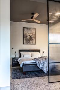 a bedroom with a bed and a ceiling fan at 208, The Duke - Luxury apartment with city views in Cape Town