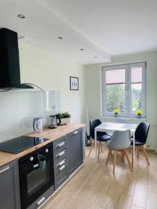 a kitchen with a table and a dining room at Apartament Sunny Home in Nowy Targ